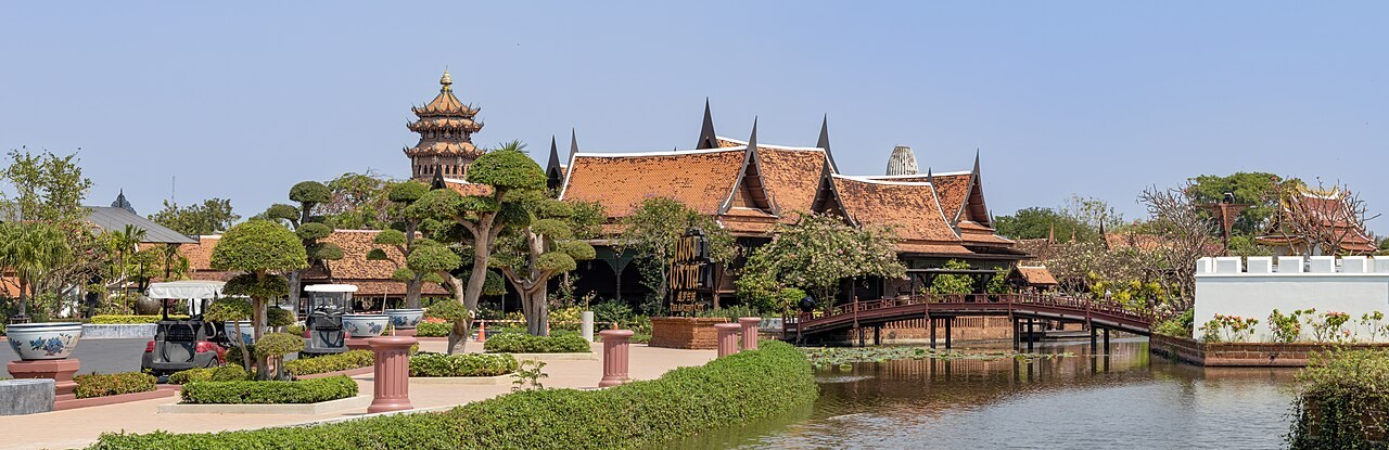 Traditional wooden building and bridge over a pond at Muang Boran