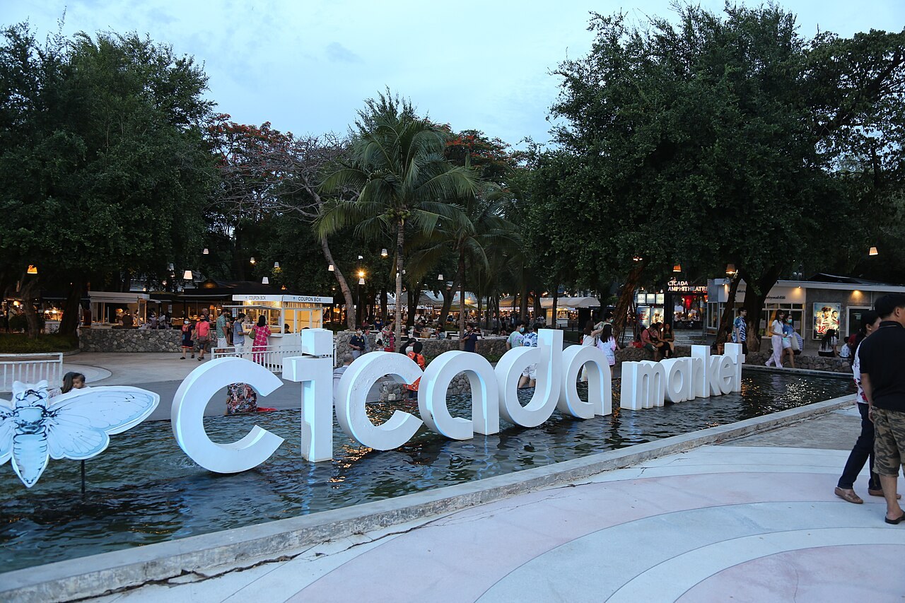 The white sign and outdoor area at Cicada Market