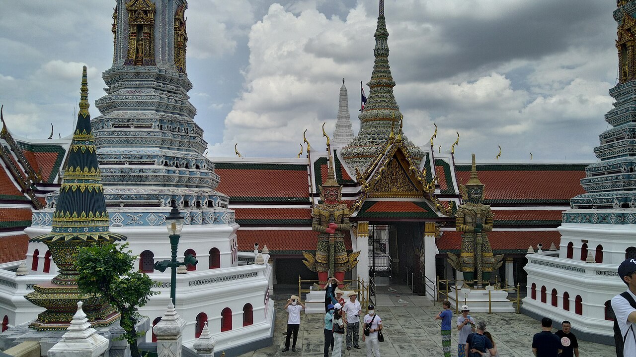 Chedi and decorated gate at Wat Phra Kaew inside the Grand Palace complex in Bangkok