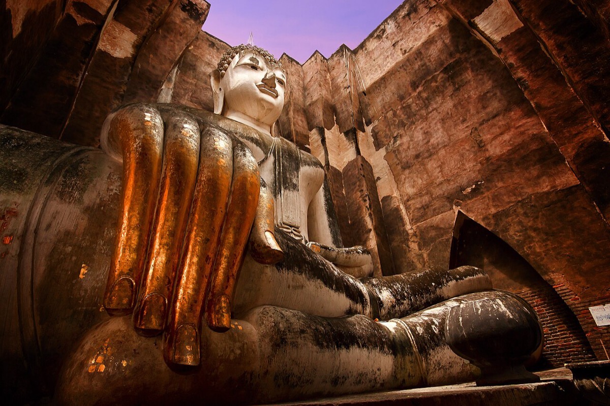 The Phra Achana seated Buddha and thick walls at Wat Si Chum in Sukhothai